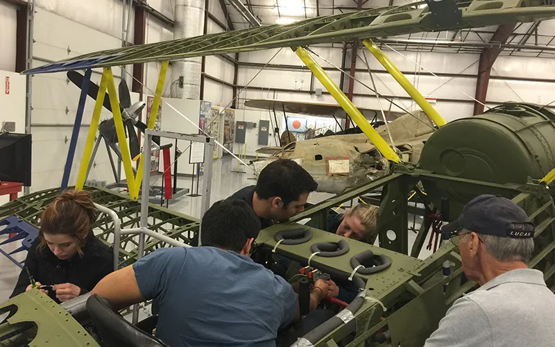 electrical engineering students working on an airplane