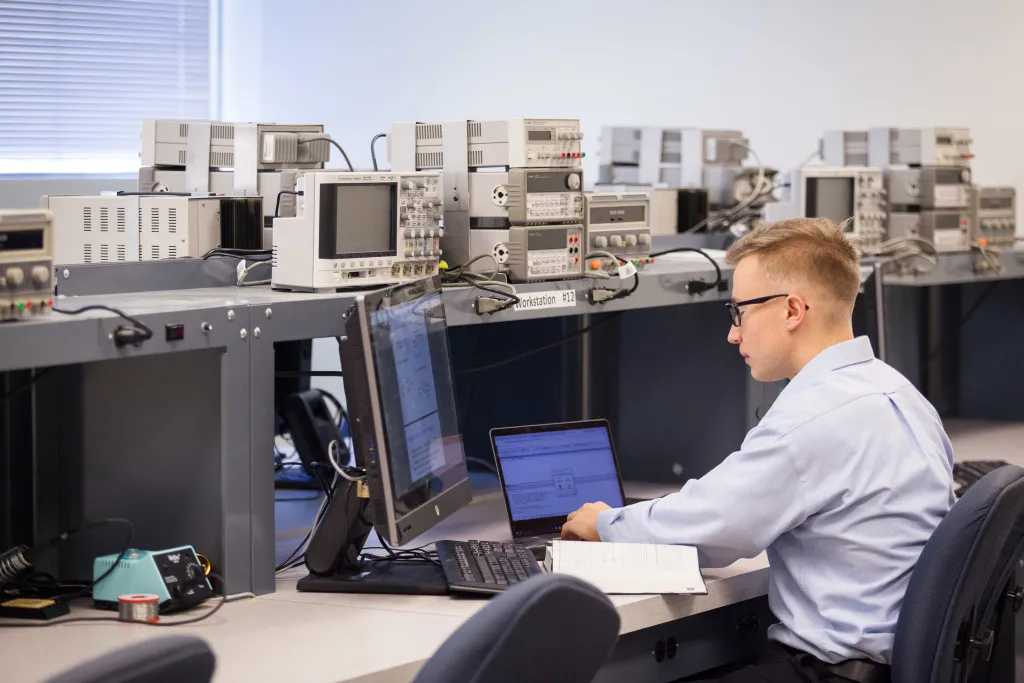 Person working at a large computer workstation.