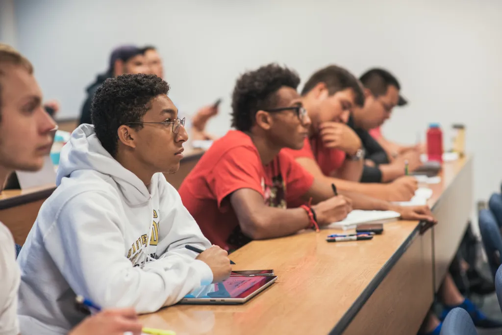 Students in a classroom watching a lecture.