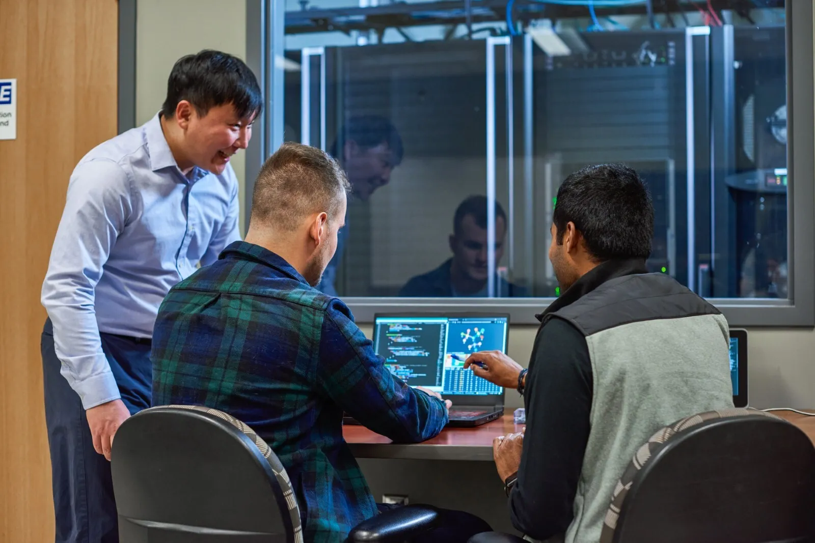 Three men working.